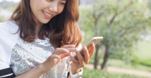 A woman using an app on her phone for her garden.