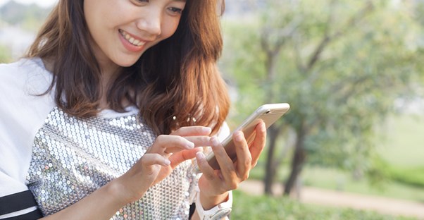 A woman using an app on her phone for her garden.
