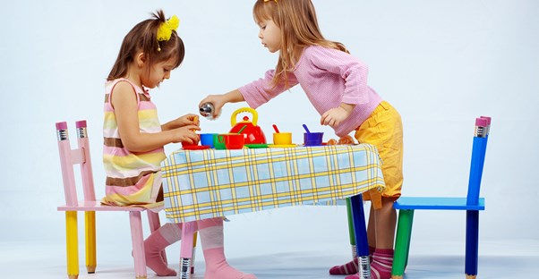 Two sisters having a tea party