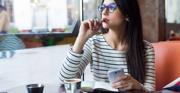 Young woman enjoying a cup of coffee by herself