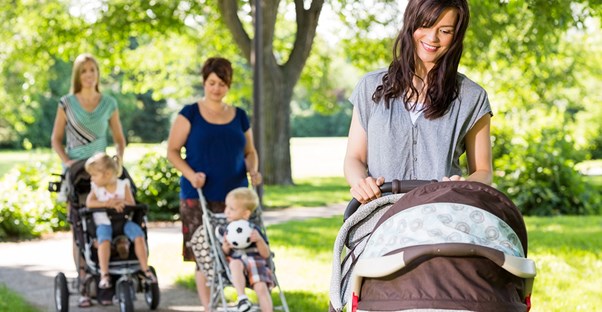 A mom spending time with her friends and child at the same time.