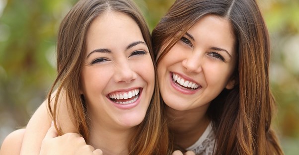 Two sisters smiling for the camera