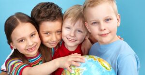 Young students play educational games with a globe