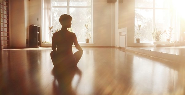 A girl does vinyasa yoga