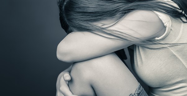 a woman is overcome with pain from her fibromyalgia