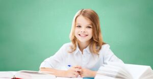 A young girl studies and does homework
