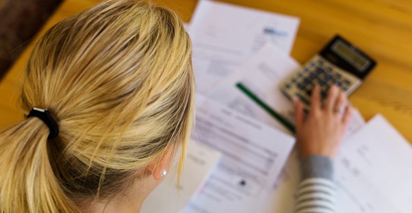 Woman adding up her expenses and income now that she is unemployed