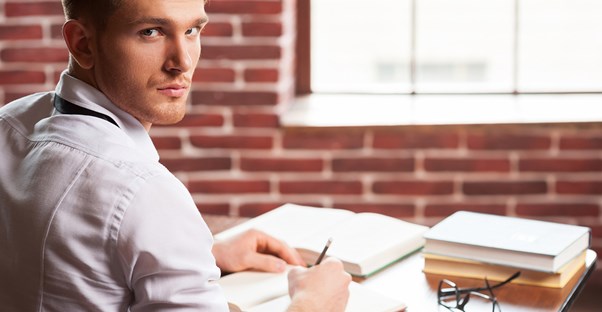Man looks creepy while writing in his journal