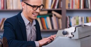 A technical writing major types on a typewriter