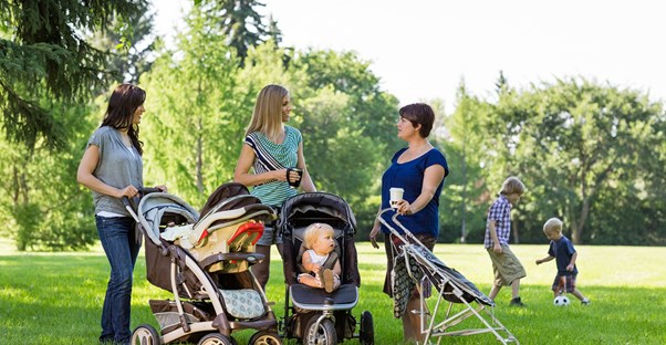 Moms talking at a play date in the park.