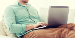 Man types on his laptop