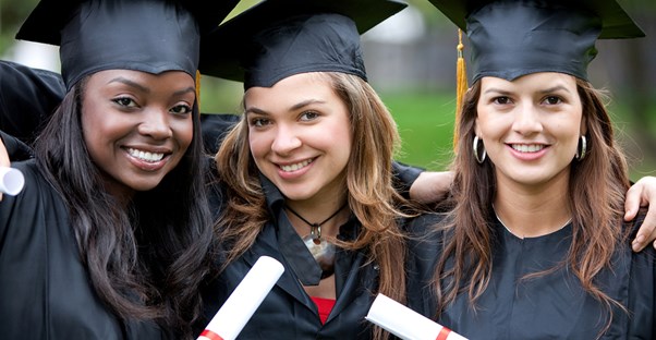 High school graduates show off their diplomas