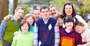 A teacher takes a group photo with his students