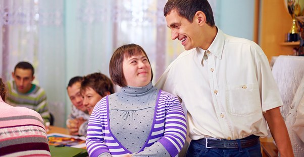 A teacher gives his student a side hug