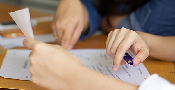 Couple filling out their income taxes at a kitchen table