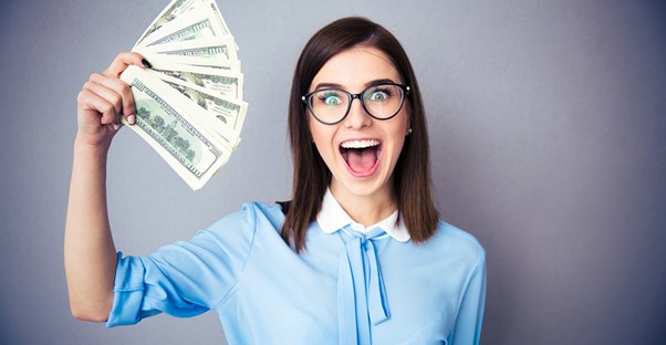 Woman holding the money she made from investing in peer to peer lending