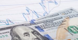 Graph of dividend yields with 100 dollar bills stacked on top