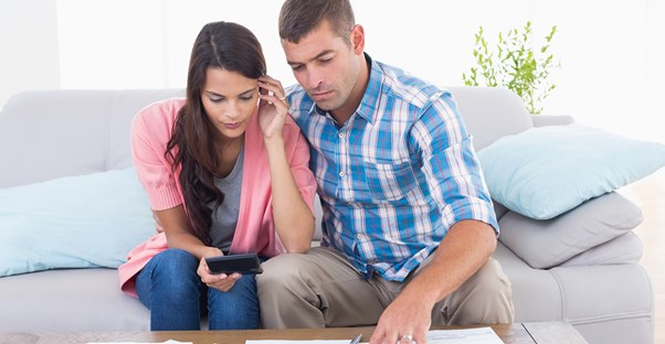 A couple calculating how much they need to save for early retirement
