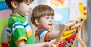 Young students play with a learning toy