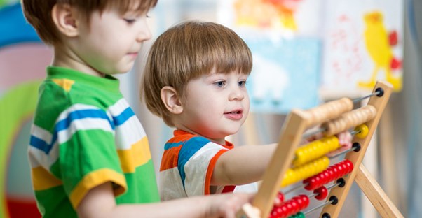 Young students play with a learning toy