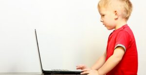 A little boy using a laptop