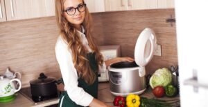 Young woman using a slow cooker