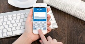Person sending money with PayPal on an iPhone