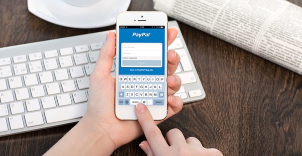 Person sending money with PayPal on an iPhone