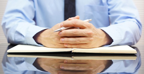 Accountant sitting at a desk preparing to audit someone