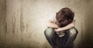 An image of a little boy representing the emotional toll of child abuse