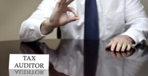 A tax auditor making the okay sign