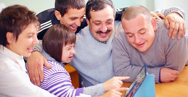 A speech pathologist works with his students