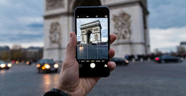 taking a picture in france to put up a review on tripadvisor