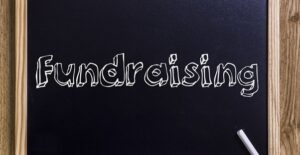Blackboard with fundraising written on it
