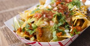 A container of nachos for a tailgate
