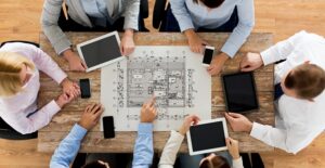 A group of architects sit around and discuss a project