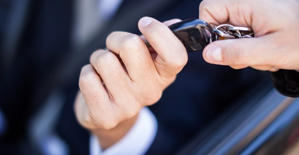 Man handing over the keys to a newly leased car