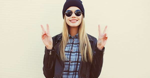 Girl showing off her round sunglasses.