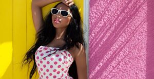 Woman modeling her outfit and sunglasses.