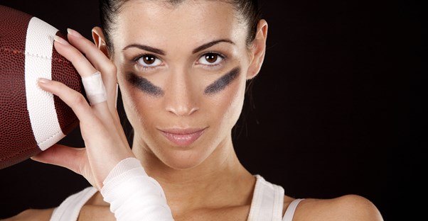 Young woman holding a football.