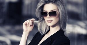 Young woman showing off her designer sunglasses