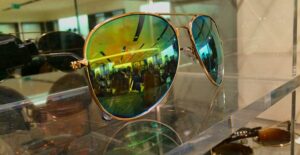 Designer sunglasses on a shelf.
