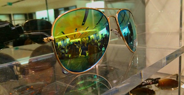 Designer sunglasses on a shelf.