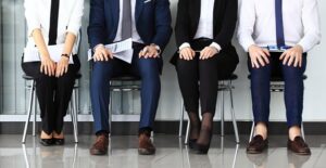 Young professionals sit and wait in a waiting room