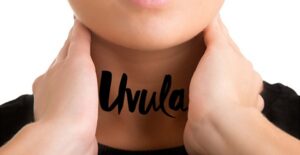 A woman touches her uvula