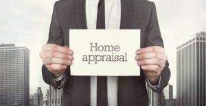 Real Estate Appraiser holding a sign that says Home Appraisal