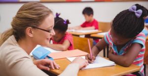 A teachers helps a student with school work