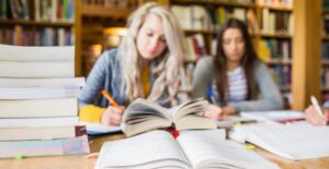 Two young college students study for finals
