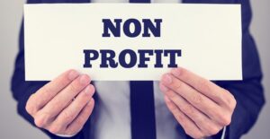 Man holding a sign that says nonprofit
