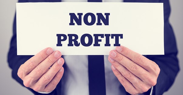 Man holding a sign that says nonprofit
